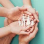 adult-children-hands-holding-paper-family-cutout-smaller